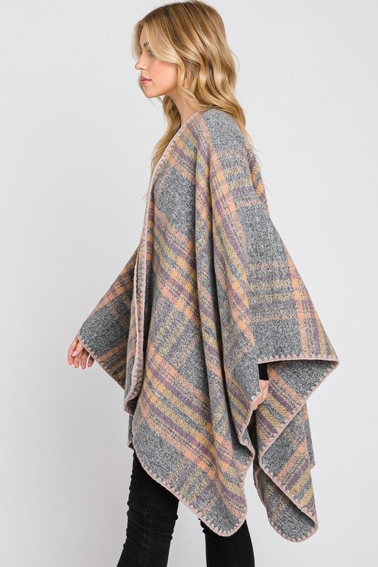 Gray plaid shawl with classic pattern and orange trim for fall style.
