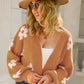 Women’s caramel cardigan with white floral detailing
