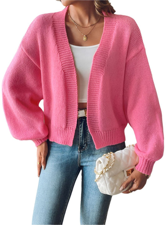 Hot pink cropped cardigan with balloon sleeves styled with jeans
