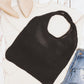 Black knit hobo bag styled for a casual everyday look.
