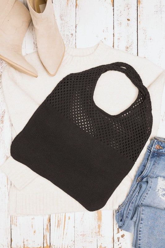 Black knit hobo bag styled for a casual everyday look.
