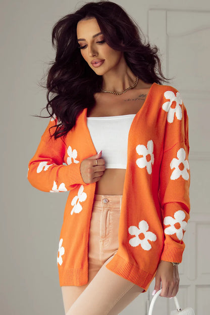 Close-up of orange floral cardigan showing flower pattern