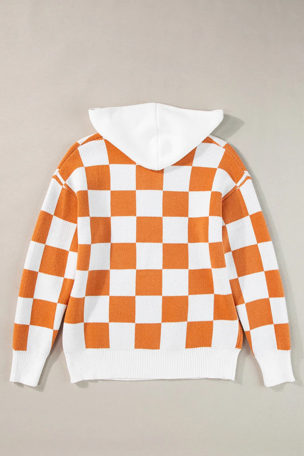 Orange and white checkered sweater with a hood, featuring a front pocket and long sleeves.
