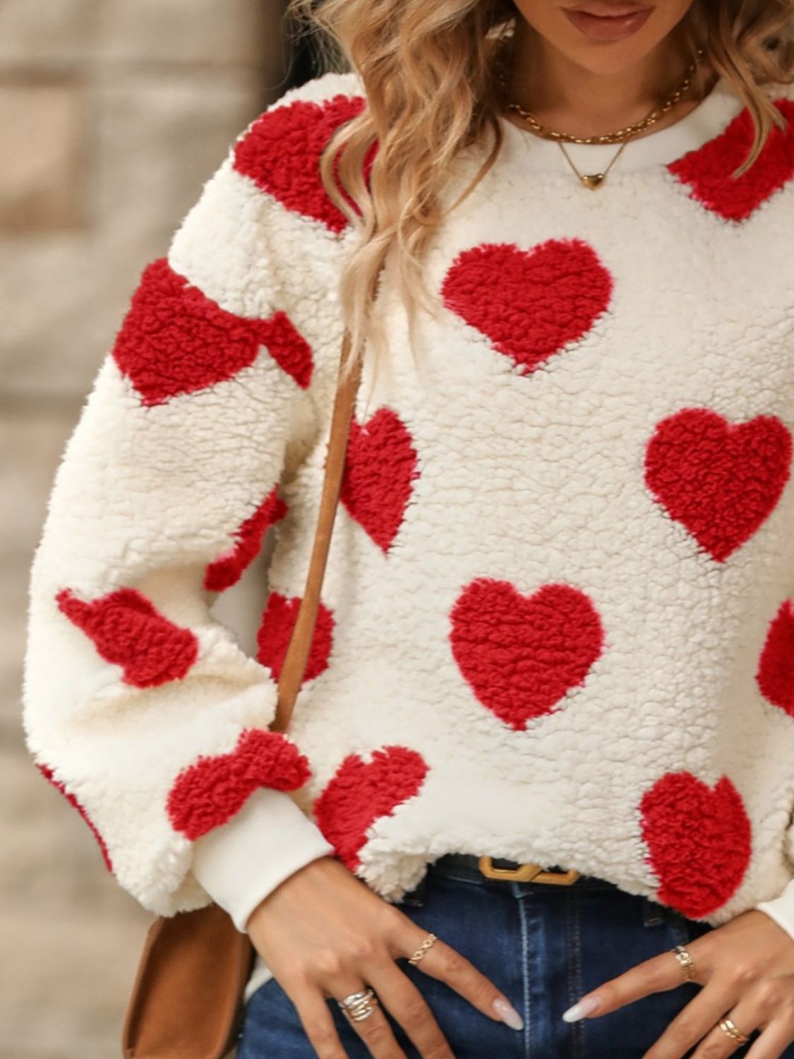 Red fuzzy heart sweatshirt styled with high-waisted jeans for fall