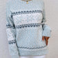 Pastel blue snowflake knit sweater with ribbed cuffs and hem, offering a soft, stylish winter look.

