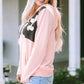 Lightweight pink pullover with cow print design and front pocket
