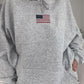 Classic gray hoodie with American flag detail, ideal for casual wear.
