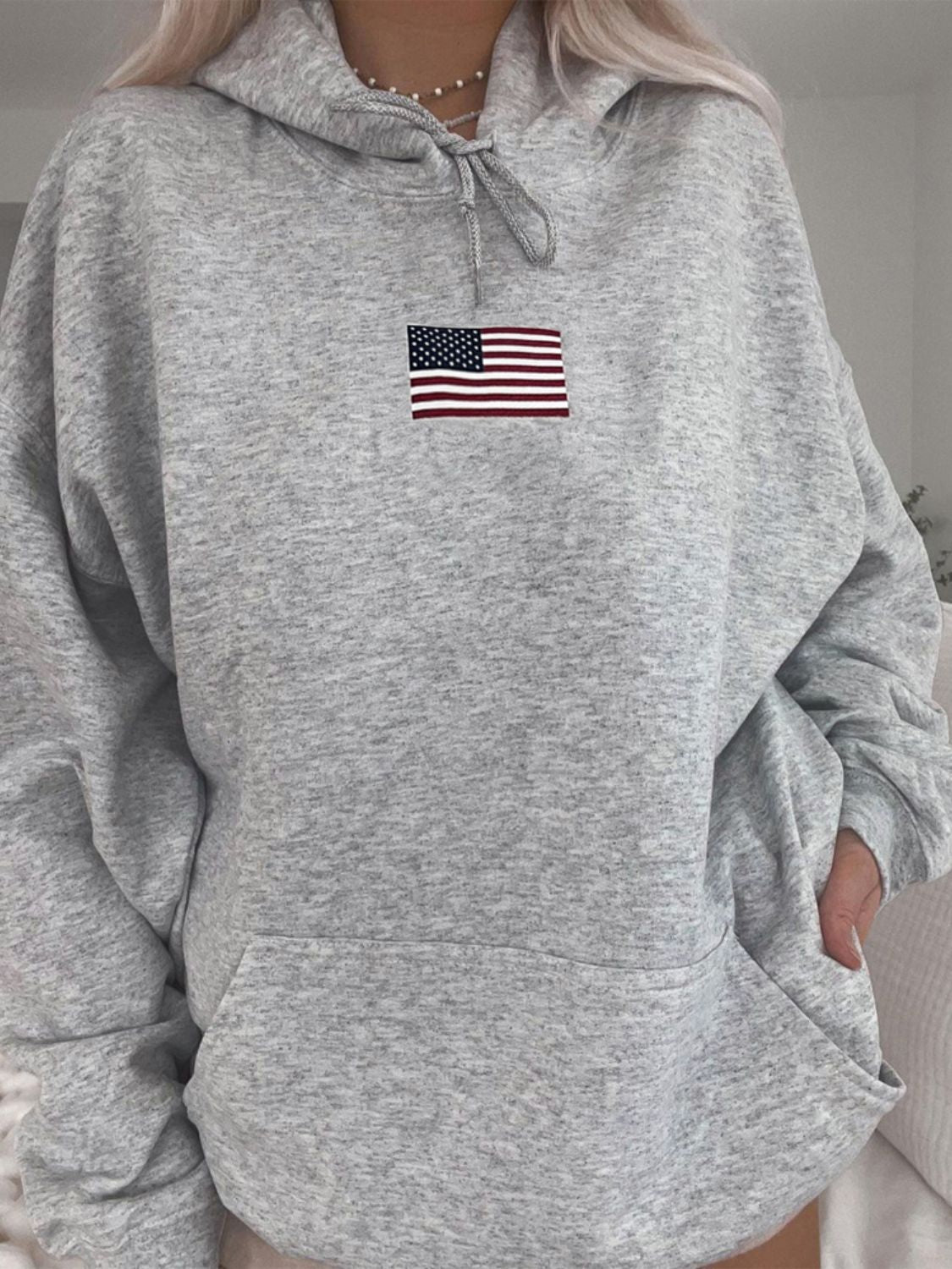 Classic gray hoodie with American flag detail, ideal for casual wear.
