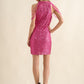 Back view of a pink bodycon dress with a zipper and beaded shoulder details.
