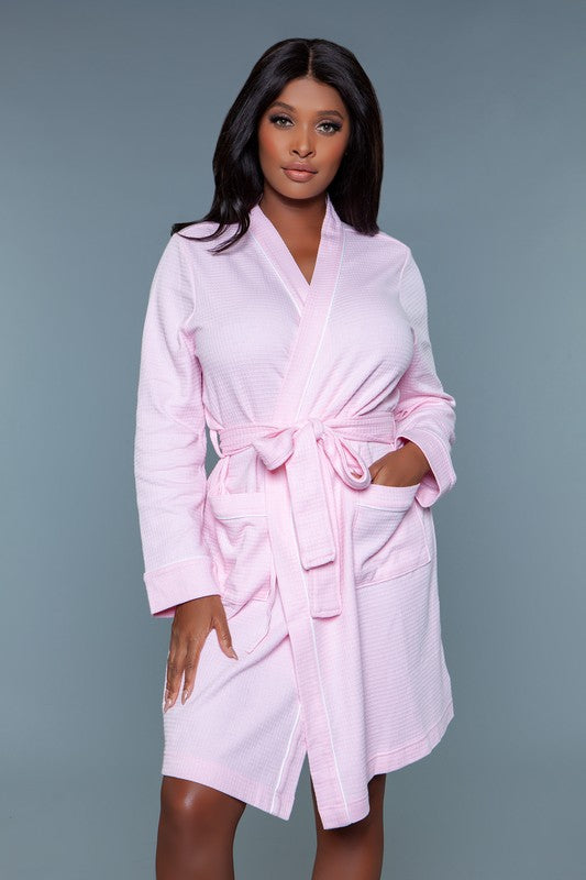 Full-length view of a pink waffle robe with a belted waist, designed for cozy lounging at home.