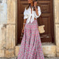 Front shot of a pink bohemian printed maxi skirt with a high-waisted design.
