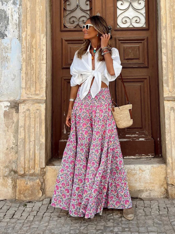 Front shot of a pink bohemian printed maxi skirt with a high-waisted design.
