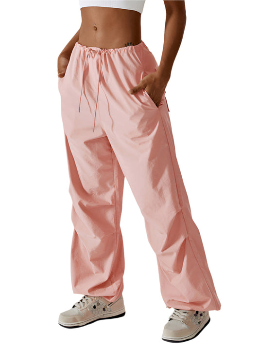 Front view of pink casual athletic pants with a drawstring waist and straight-leg design.
