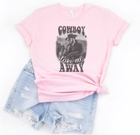 Pink graphic tee featuring a cowboy with the phrase 'Cowboy Take Me Away'