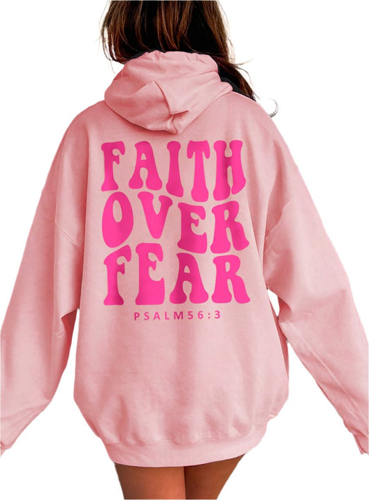 Pink oversized "Faith Over Fear" hoodie with bold lettering and Psalm 56:3 quote.