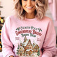 Cozy pink holiday sweatshirt featuring North Pole Gingerbread Bakery graphic.