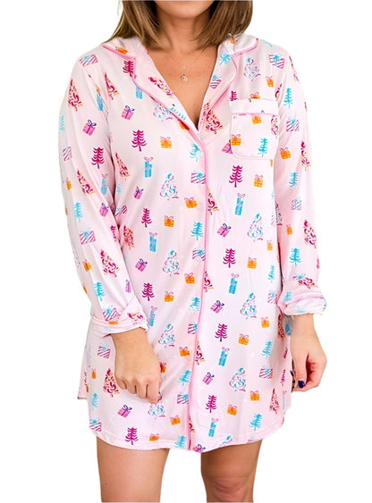 Pink holiday-themed nightshirt with colorful gift and tree print, front view.
