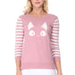 Woman wearing a pink sweater with a cute kitty face and striped sleeves.
