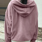 Woman in a pink fleece pullover, perfect for chilly days.
