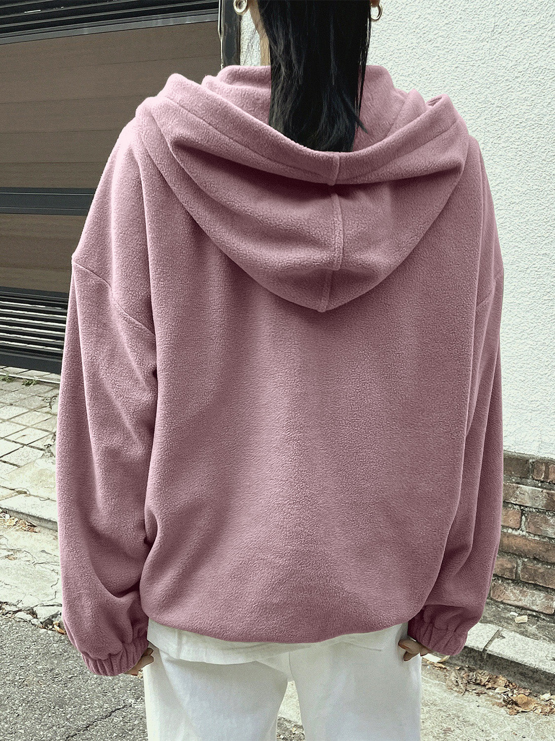 Woman in a pink fleece pullover, perfect for chilly days.
