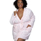 Woman wearing a pink polka dot plush robe with a front tie belt, styled for loungewear.
