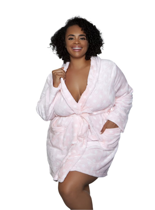 Woman wearing a pink polka dot plush robe with a front tie belt, styled for loungewear.
