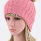 Playful pink ribbed knit winter hat with a faux fur pom accent.
