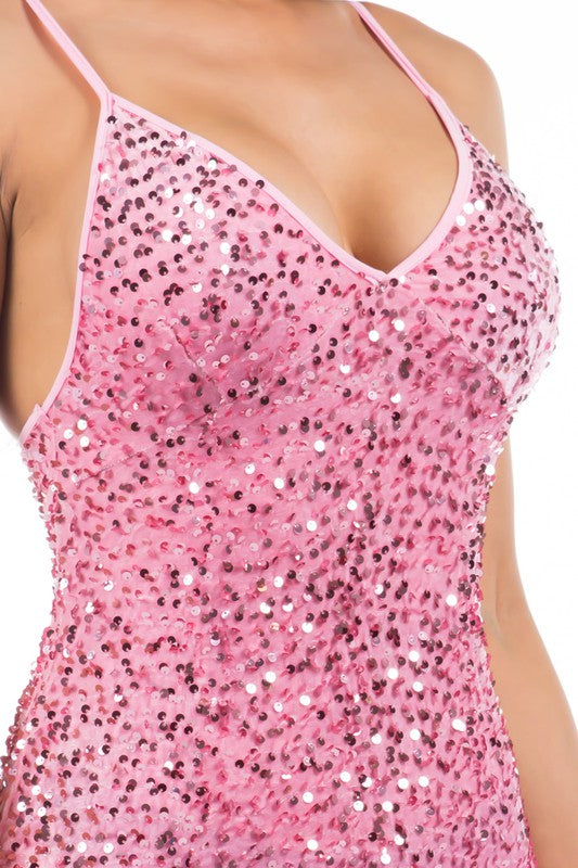 Close-up of the shimmering sequin details on a pink v-neck party dress.
