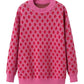 Front view of a playful pink sweater featuring a strawberry pattern, perfect for fun winter wear.

