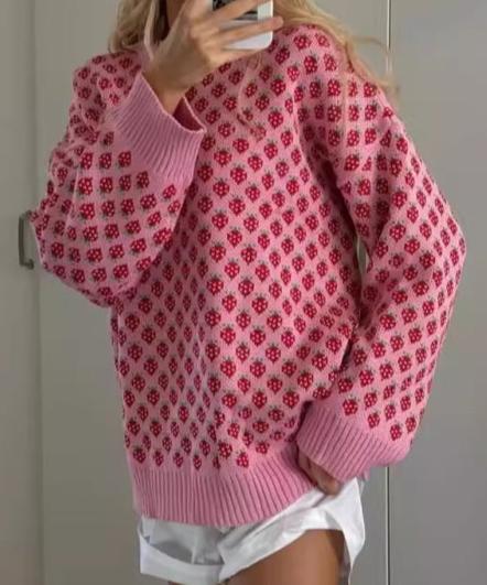 Full-length view of the pink strawberry knit sweater styled with shorts, ideal for casual and fun looks.

