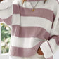 Retro-inspired pink striped sweater, ideal for layering in cooler weather.
