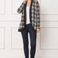 Front view of plaid cardigan with black trim, paired with a white top