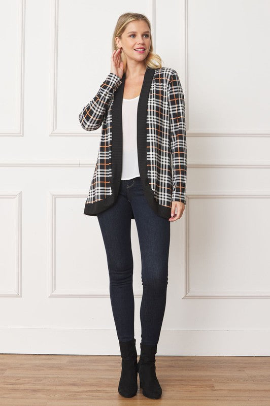 Front view of plaid cardigan with black trim, paired with a white top