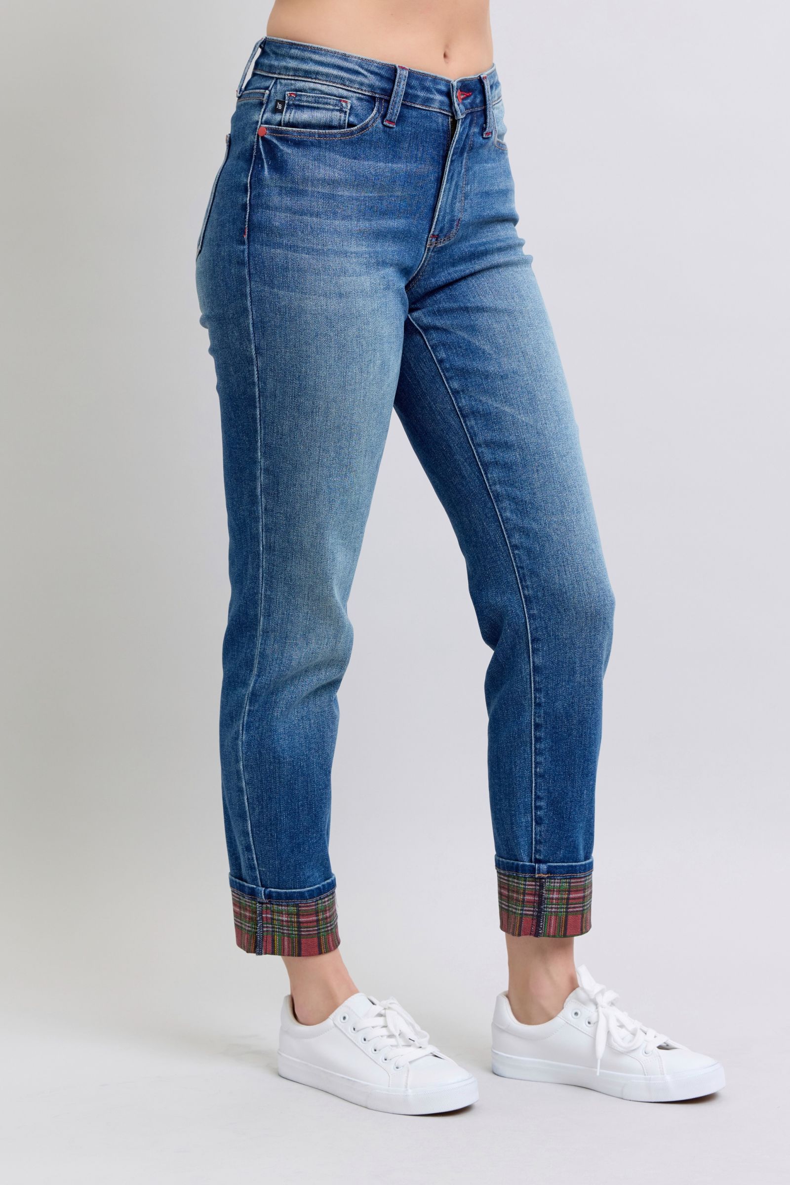 Straight leg jeans with festive plaid cuff details.
