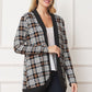 Side view of plaid open-front cardigan with black trim