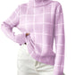 Woman wearing pink plaid turtleneck sweater with white pants