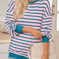 Casual pink striped sweater in soft fabric, ideal for cooler days.
