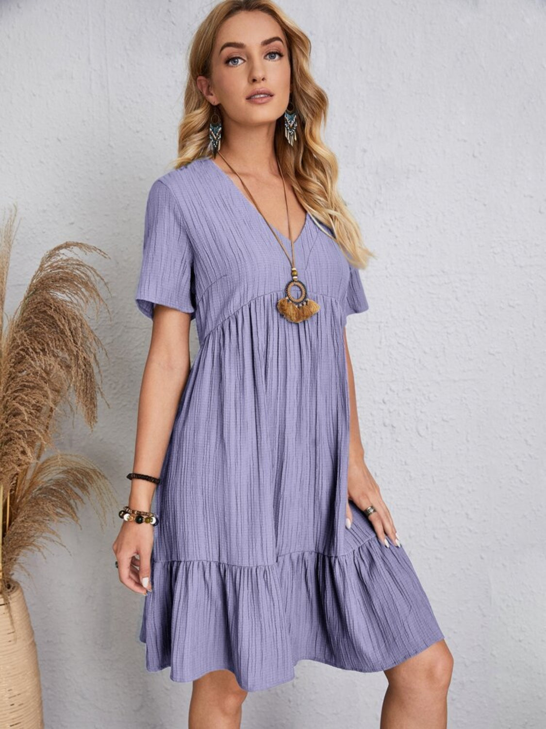 Playful purple babydoll dress with a V-neckline and flowy silhouette, perfect for summer
