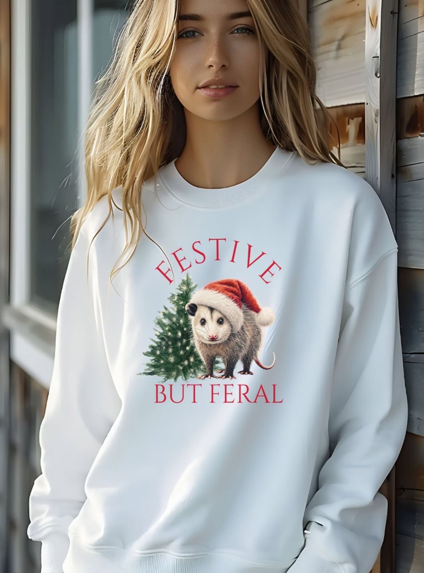 White "Festive but Feral" opossum sweatshirt, ideal for a unique holiday look.
