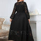 Back view of a plus-size black lace dress with a flowing silhouette.
