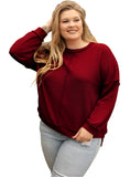 Plus-size woman wearing a burgundy waffle-knit top in a relaxed fit