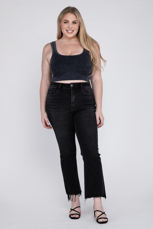 Front detail of stretchy plus-size high-rise crop flare jeans in black.
