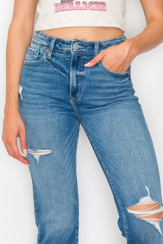 Plus-size distressed tapered leg jeans in light wash with a flattering fit.
