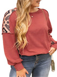 Plus-size red sweatshirt with geometric prints and exposed seam details.
