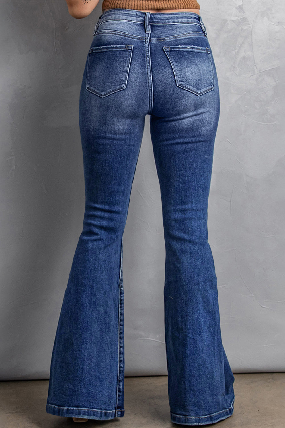 Women's plus size flare jeans with stitched details and high-rise fit.
