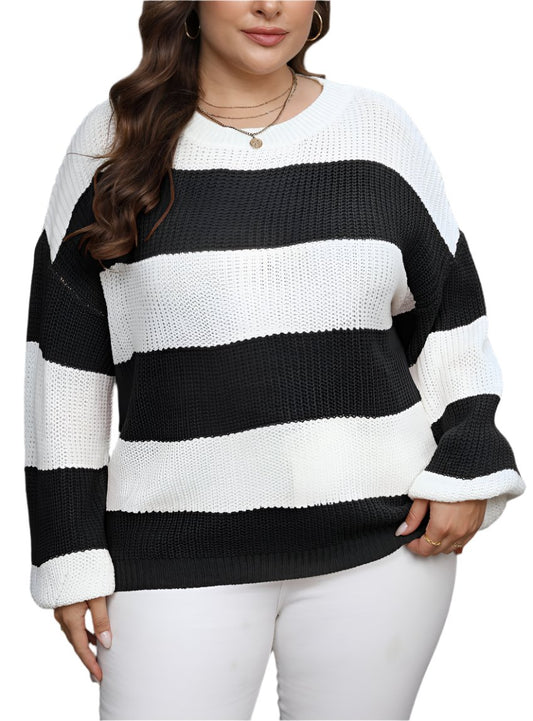 Woman wearing a plus size striped crewneck sweater in black and white