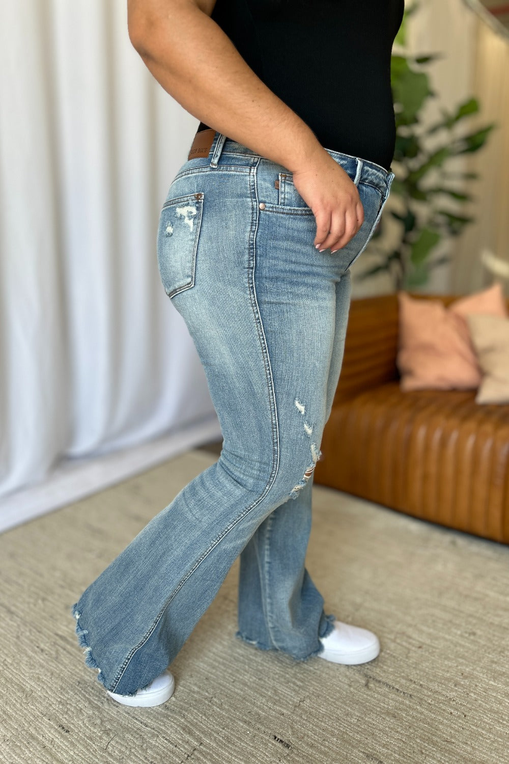 Judy Blue flare jeans featuring tummy control and modern distressed details.
