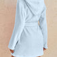 Plush hooded fleece robe in sky blue, shown on model for cozy loungewear.
