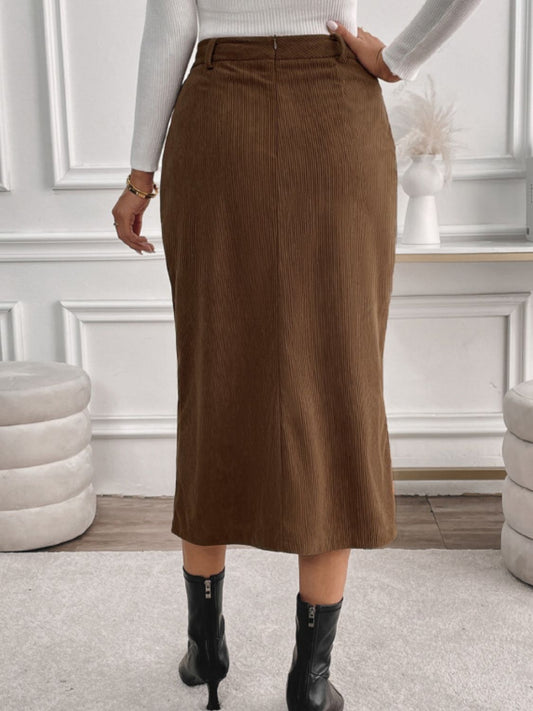 Stylish brown corduroy skirt with high waist, front slit, and pockets.
