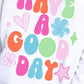 Close-up of cheerful "Have A Good Day" message on women’s pullover.
